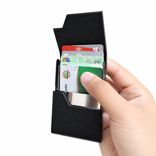 Close-up of the polished stainless steel fold-over clasp on a minimalist black leather card and cash organizer.